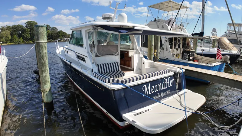  Yacht Photos Pics 2013 Back Cove 34 boat docked, featuring striped seating and "MeandHer" name on the stern.