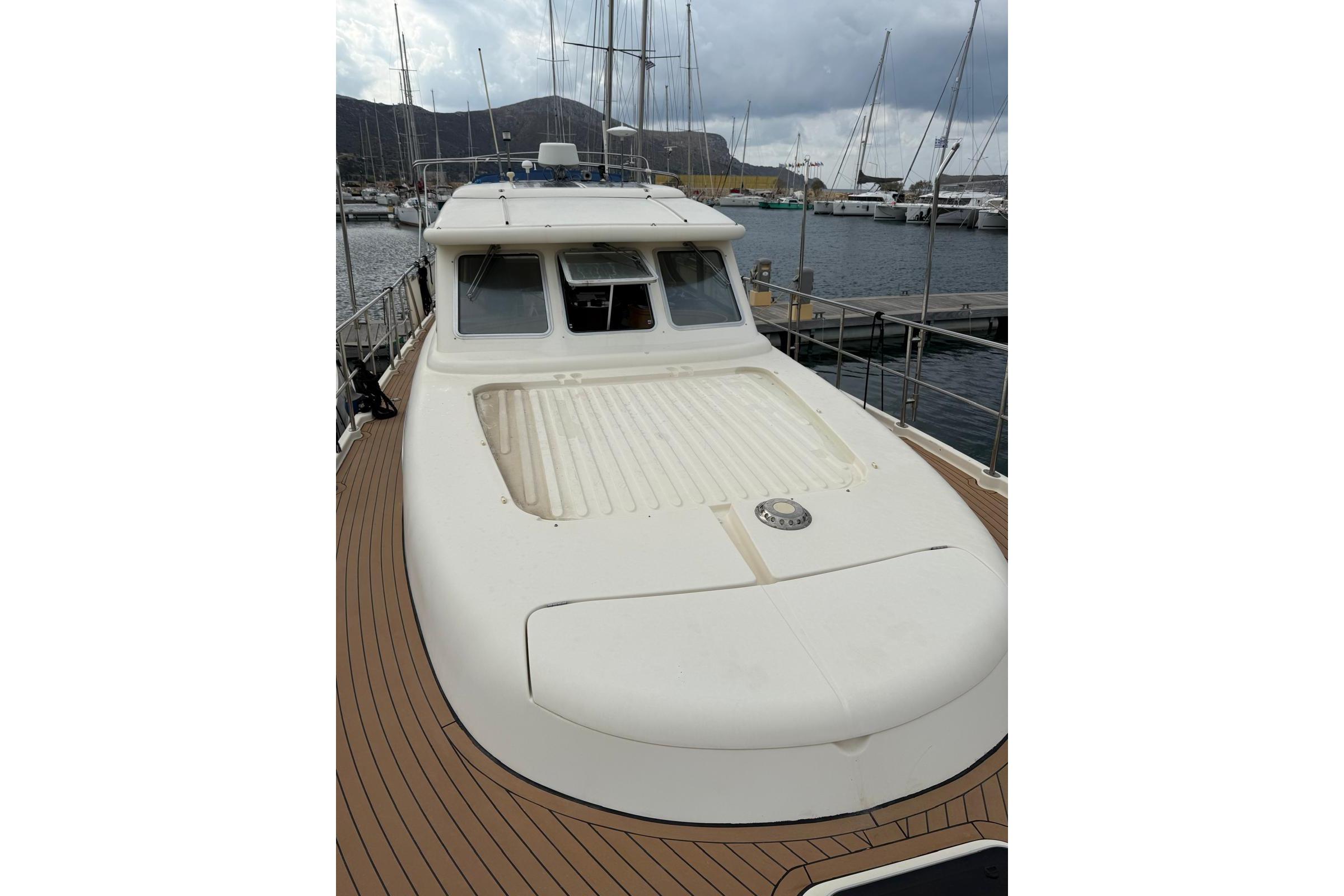 Elling E3 2000 yacht docked at marina, showcasing sleek design and spacious deck.