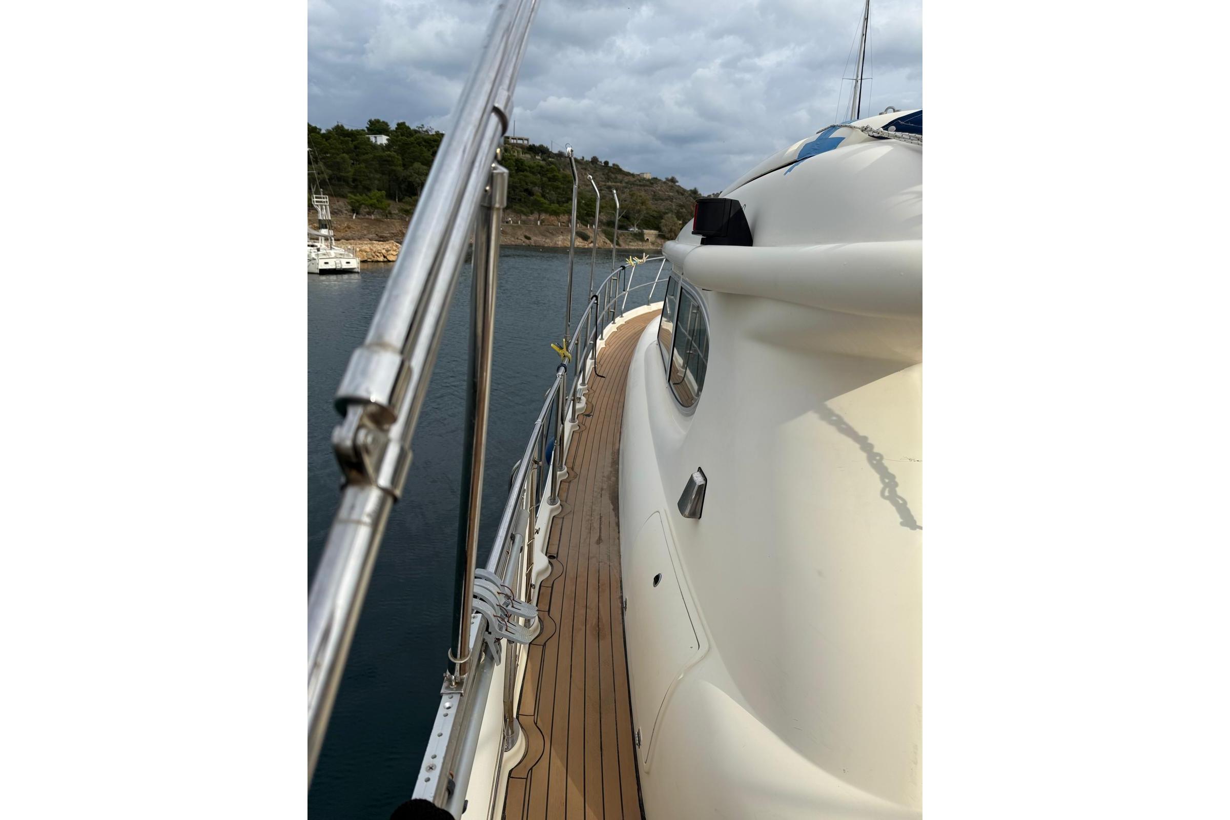 Elling E3 yacht from 2000, docked with wooden deck and scenic background.