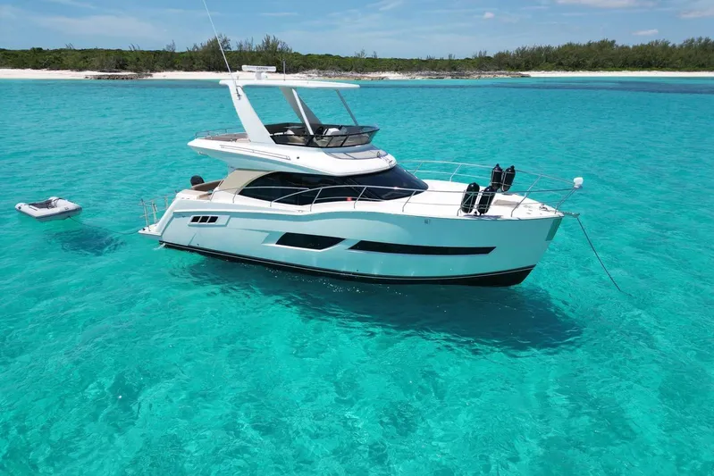 Saline Dion Yacht Photos Pics Luxurious 2017 Carver C40 yacht anchored in clear turquoise waters near a sandy beach.