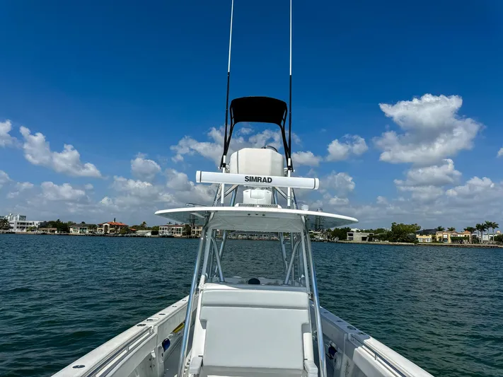  Yacht Photos Pics 2022 Contender 39 ST boat on calm waters under a clear blue sky.