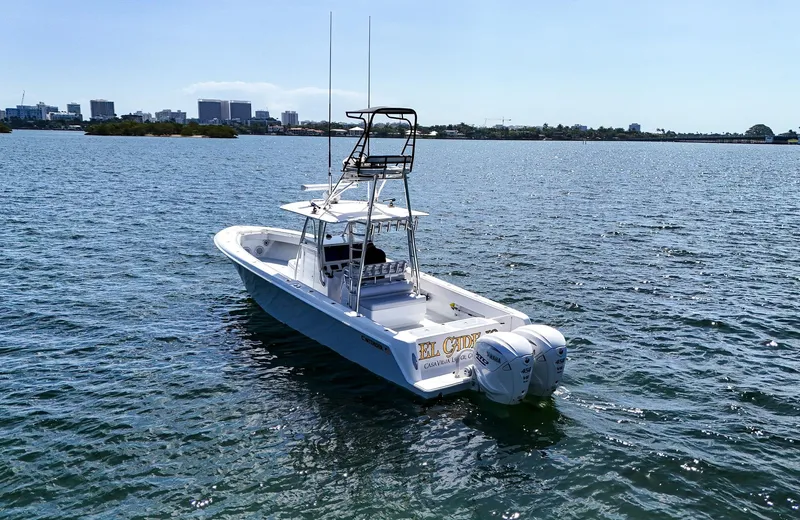  Yacht Photos Pics 2022 Contender 39 ST boat on open water with city skyline in background.