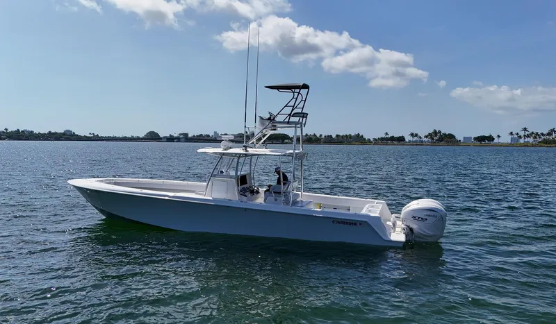  Yacht Photos Pics 2022 Contender 39 ST boat on calm water with clear sky background.