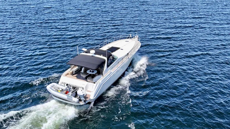 Top Gunns Yacht Photos Pics 1998 Sea Ray 500 Sundancer cruising on open water, aerial view.