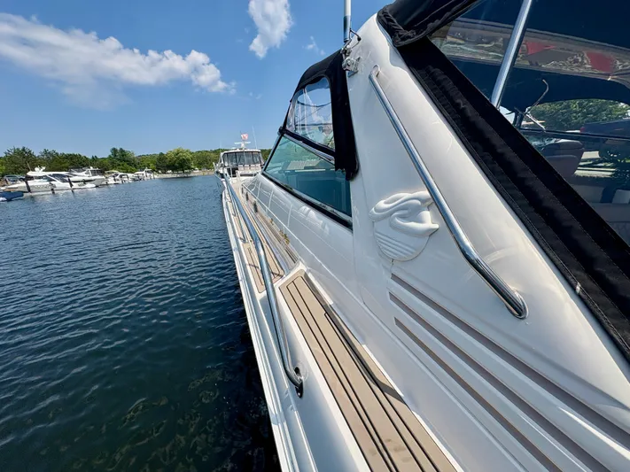Top Gunns Yacht Photos Pics 1998 Sea Ray 500 Sundancer yacht docked on a sunny day, side view.