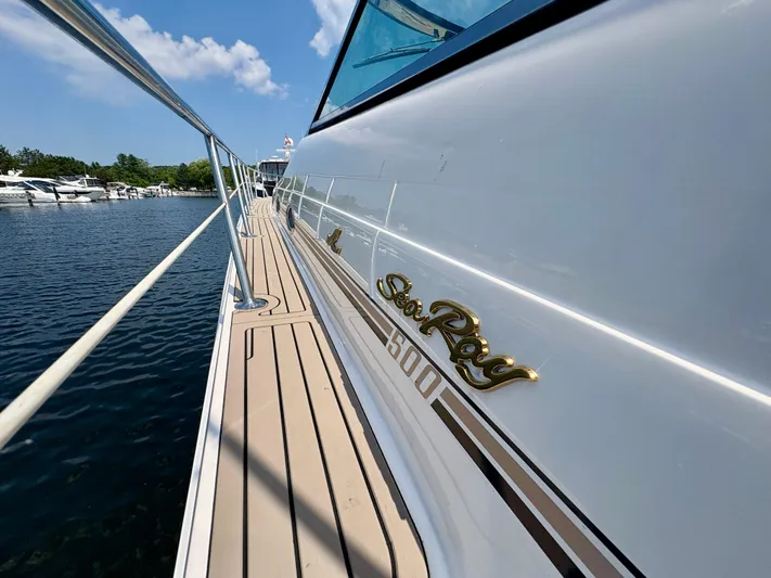 Top Gunns Yacht Photos Pics 1998 Sea Ray 500 Sundancer yacht docked, showcasing sleek design and branding.