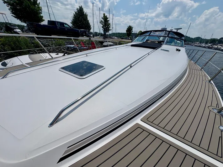 Top Gunns Yacht Photos Pics 1998 Sea Ray 500 Sundancer yacht docked, showcasing sleek deck design and marina background.
