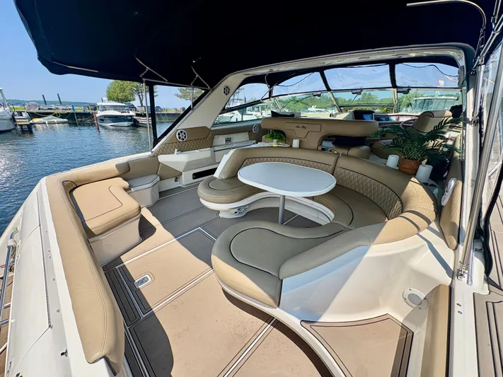 Top Gunns Yacht Photos Pics 1998 Sea Ray 500 Sundancer yacht interior with spacious seating and table, docked at marina.