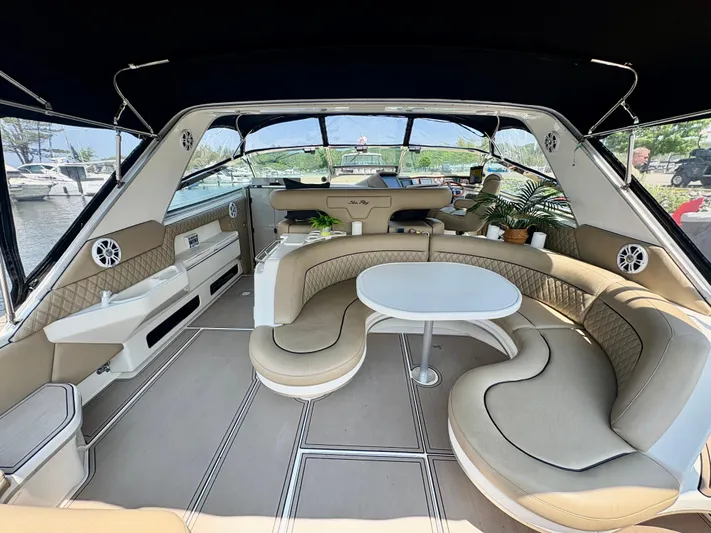 Top Gunns Yacht Photos Pics Luxurious interior of a 1998 Sea Ray 500 Sundancer yacht with elegant seating and table.