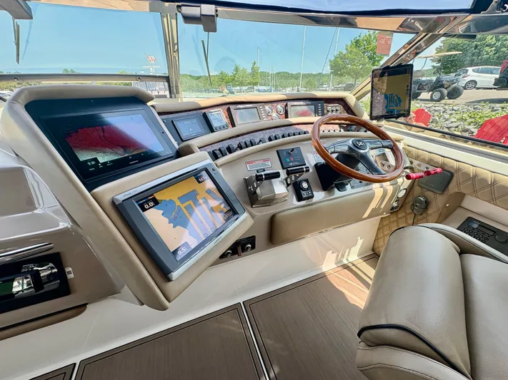 Top Gunns Yacht Photos Pics 1998 Sea Ray 500 Sundancer helm with advanced navigation displays and luxurious leather seating.