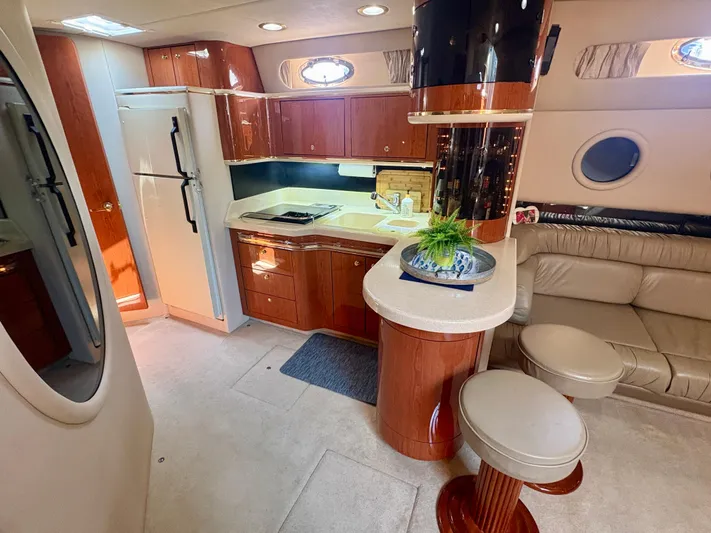 Top Gunns Yacht Photos Pics Luxurious interior of 1998 Sea Ray 500 Sundancer yacht with kitchen and seating area.
