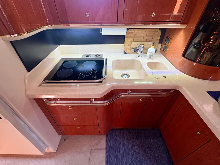 Top Gunns Yacht Photos Pics Luxurious kitchen area in a 1998 Sea Ray 500 Sundancer yacht with modern amenities.