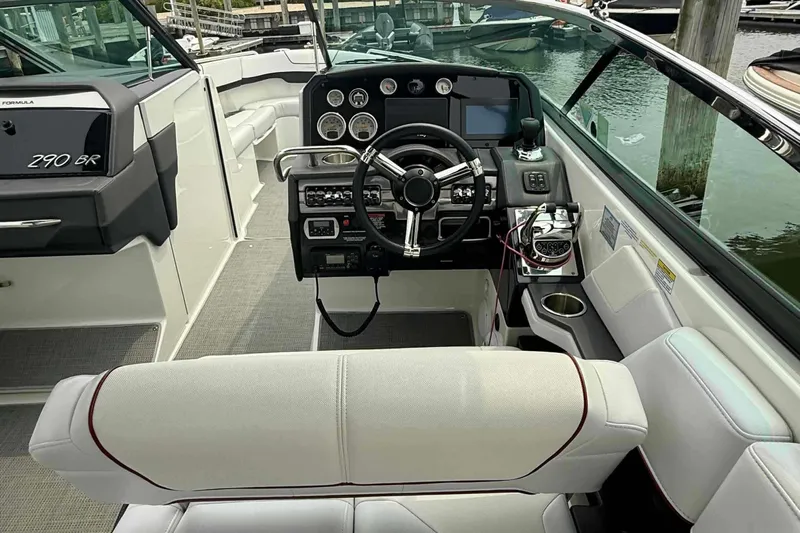  Yacht Photos Pics 2020 Formula 290 Bowrider cockpit with steering wheel, dashboard, and seating.