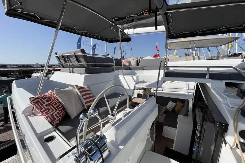  Yacht Photos Pics 2023 Fountaine Pajot Tanna 47 yacht interior with modern seating and helm station.