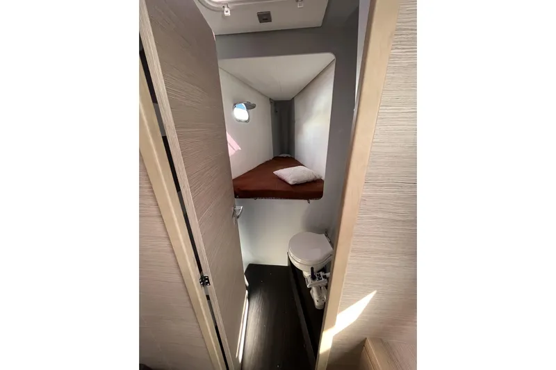  Yacht Photos Pics 2023 Fountaine Pajot Tanna 47 cabin interior with bed and compact bathroom.