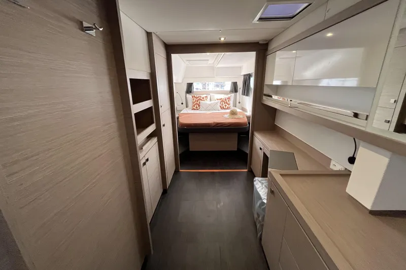  Yacht Photos Pics Luxurious interior of 2023 Fountaine Pajot Tanna 47 catamaran, featuring modern design and cozy bedroom.