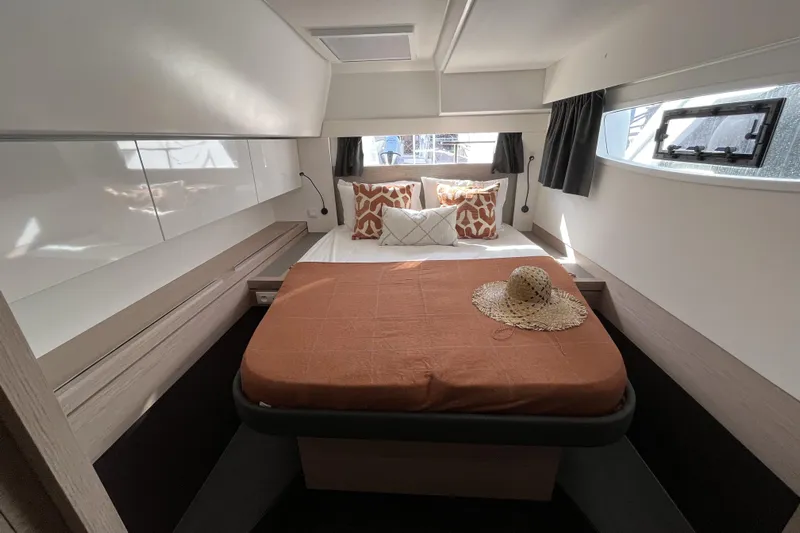 Yacht Photos Pics Luxurious cabin interior of 2023 Fountaine Pajot Tanna 47 catamaran with stylish bedding.