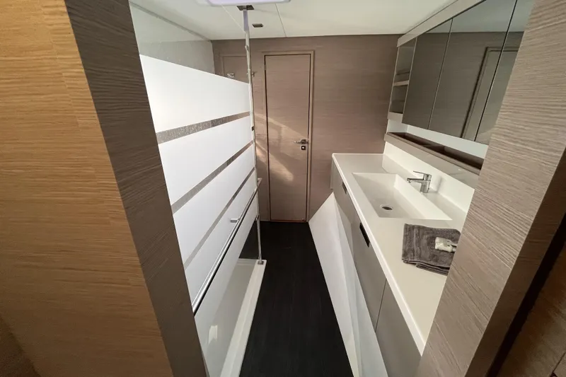  Yacht Photos Pics Modern bathroom interior of 2023 Fountaine Pajot Tanna 47 yacht, featuring sleek design and fixtures.
