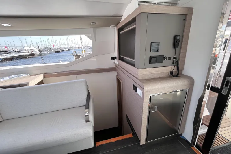  Yacht Photos Pics Interior of 2023 Fountaine Pajot Tanna 47 yacht with modern seating and marina view.