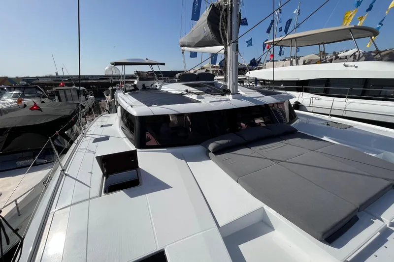  Yacht Photos Pics 2023 Fountaine Pajot Tanna 47 catamaran with spacious deck and modern design at a marina.