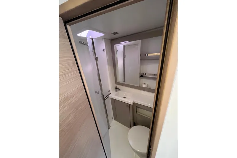  Yacht Photos Pics Modern bathroom in 2023 Fountaine Pajot Tanna 47 yacht, featuring sleek design and amenities.