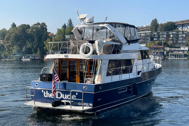 The Dude Yacht Photos Pics 1995 Ocean Alexander 486 yacht named "The Dude" cruising on a scenic waterway.