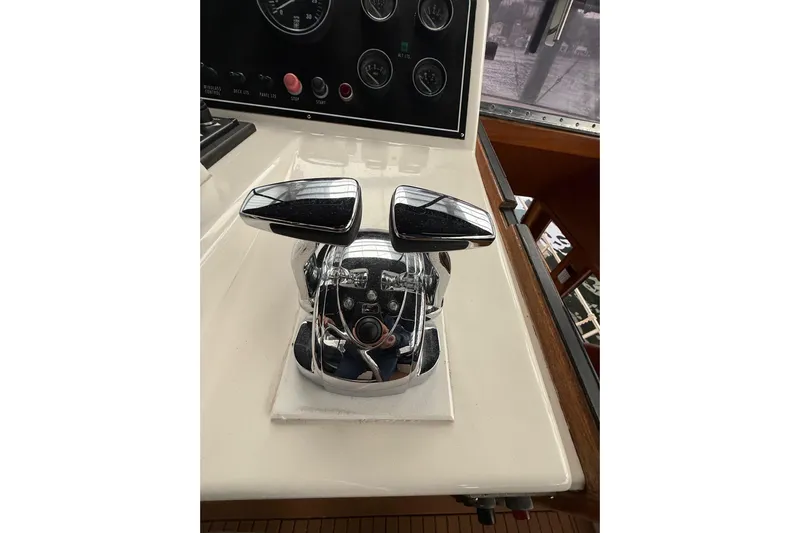The Dude Yacht Photos Pics Chrome throttle controls on a 1995 Ocean Alexander 486 yacht dashboard.