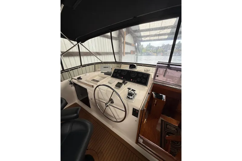 The Dude Yacht Photos Pics 1995 Ocean Alexander 486 yacht helm with steering wheel and navigation instruments.