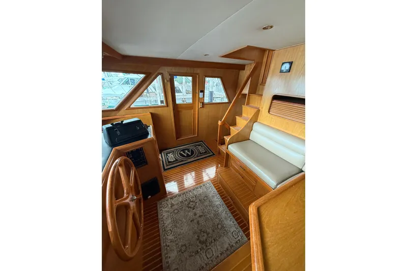 The Dude Yacht Photos Pics Interior of 1995 Ocean Alexander 486 yacht with wooden finish and seating area.