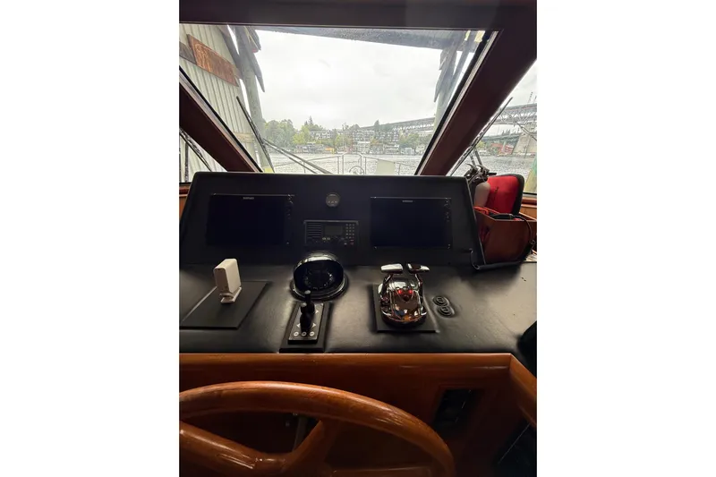 The Dude Yacht Photos Pics 1995 Ocean Alexander 486 yacht helm with navigation equipment and steering wheel.