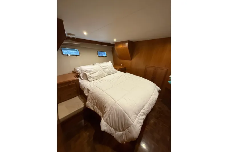 The Dude Yacht Photos Pics Luxurious bedroom interior of 1995 Ocean Alexander 486 yacht with cozy bedding.