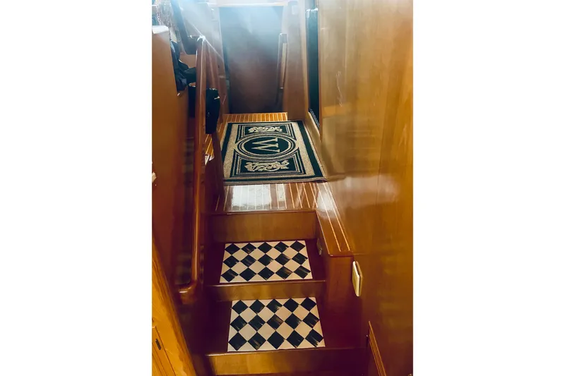 The Dude Yacht Photos Pics Staircase with checkered steps on 1995 Ocean Alexander 486 yacht interior.