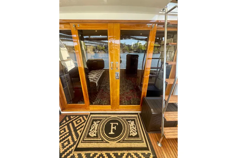 The Dude Yacht Photos Pics Luxury yacht Ocean Alexander 486, 1995 model, with elegant wooden doors and custom mat.