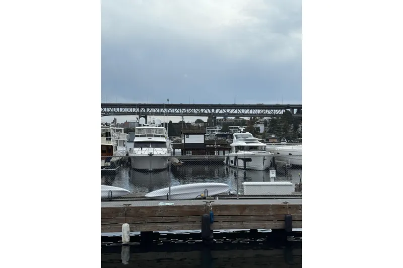 The Dude Yacht Photos Pics Marina with Ocean Alexander 486 yacht, 1995 model, docked under cloudy skies.
