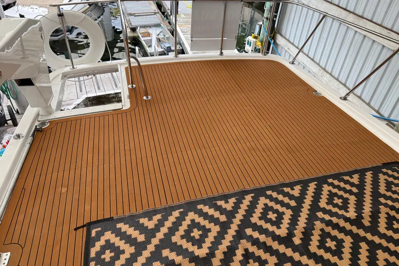 The Dude Yacht Photos Pics 1995 Ocean Alexander 486 yacht deck with patterned rug and railing.
