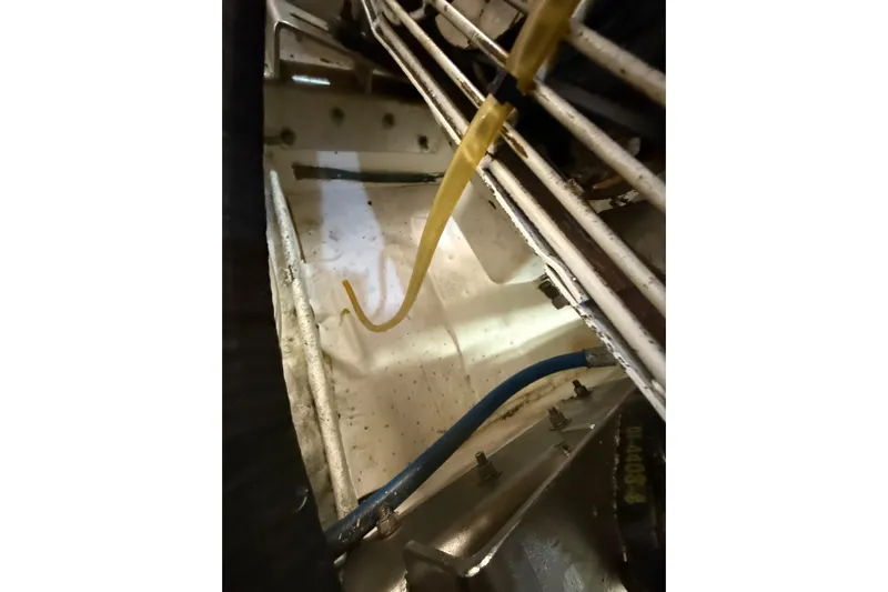 The Dude Yacht Photos Pics Engine compartment of 1995 Ocean Alexander 486 yacht, showing hoses and wiring.