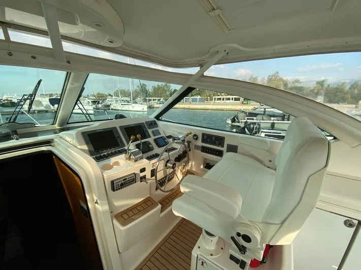 Yacht Photos Pics Helm of 2006 Tiara Yachts 42, featuring modern controls and comfortable seating.