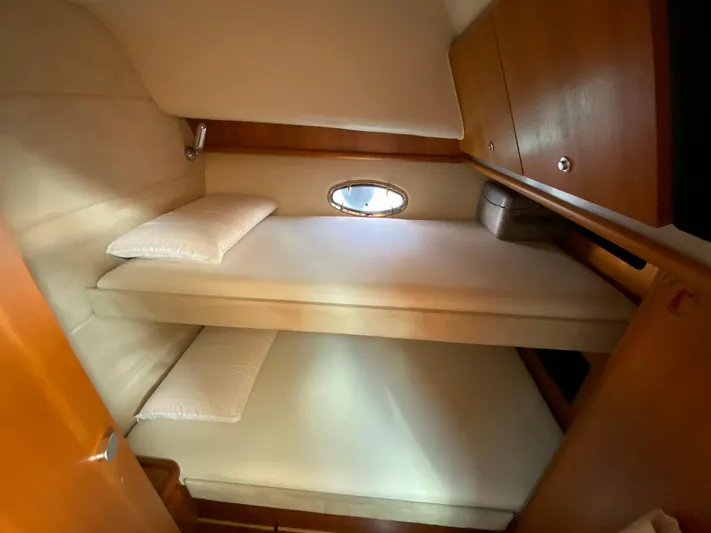  Yacht Photos Pics 2006 Tiara Yachts 42 interior cabin with bunk beds and wooden cabinetry.