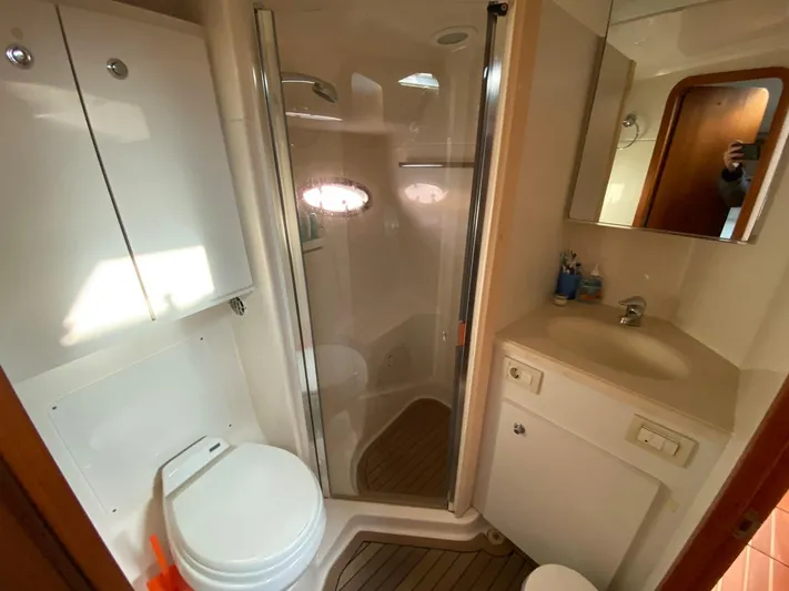 Yacht Photos Pics Bathroom interior of 2006 Tiara Yachts 42, featuring shower, toilet, and sink.