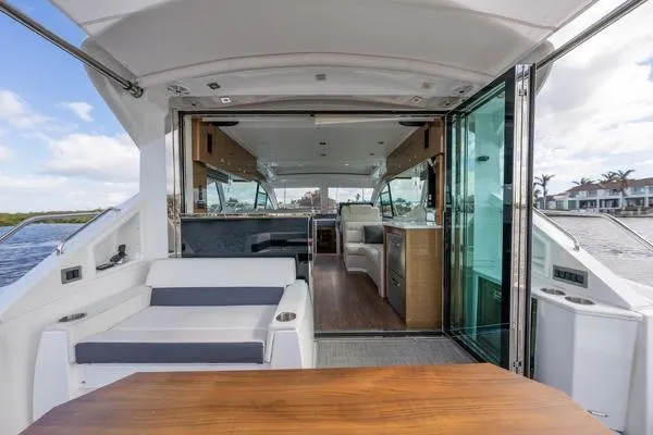  Yacht Photos Pics 2018 Cruisers Yachts 50 Cantius interior with open deck, modern seating, and glass doors.