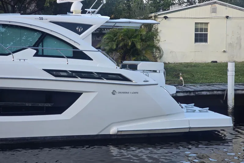  Yacht Photos Pics 2018 Cruisers Yachts 50 Cantius docked by a waterfront property.