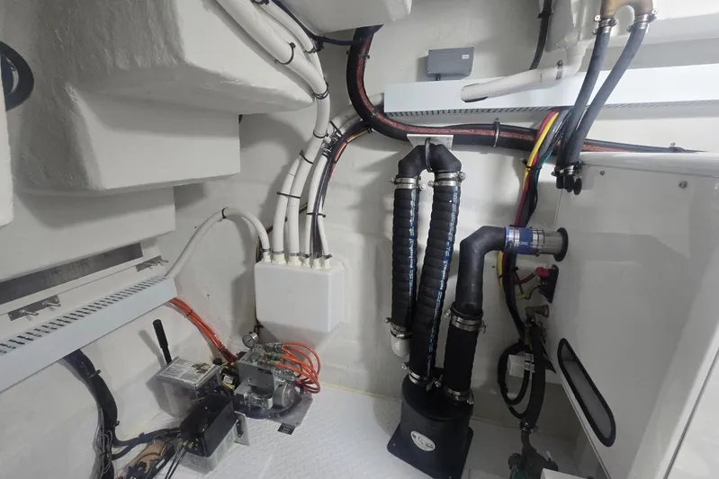  Yacht Photos Pics Engine room of 2018 Cruisers Yachts 50 Cantius with visible pipes and equipment.