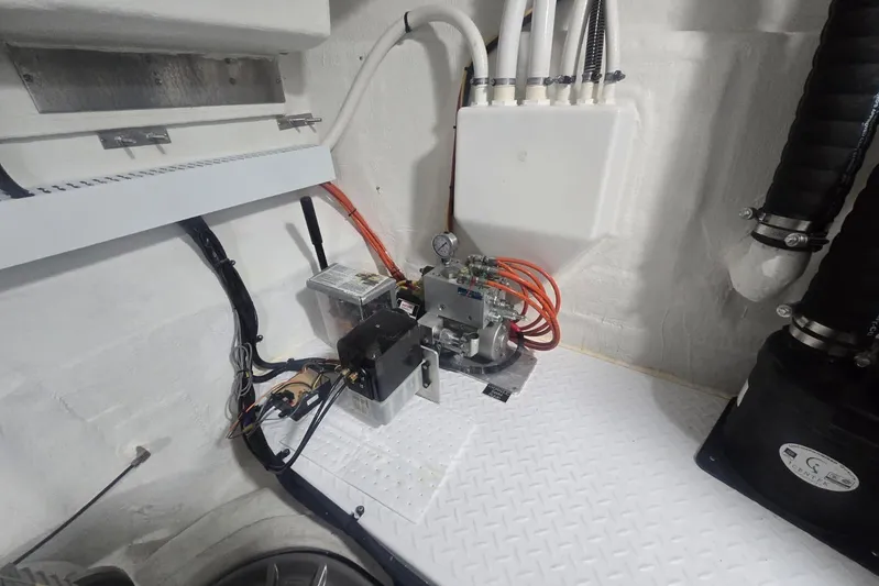  Yacht Photos Pics Engine room of 2018 Cruisers Yachts 50 Cantius, showcasing mechanical components and wiring.