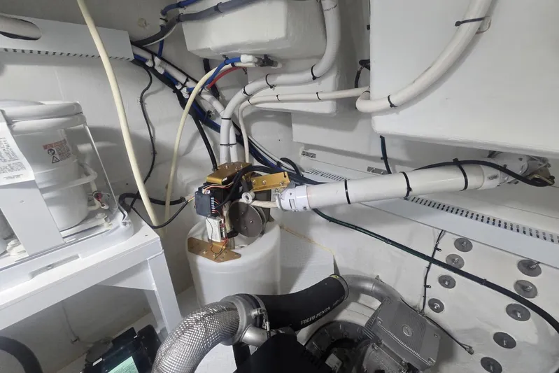  Yacht Photos Pics Engine room of 2018 Cruisers Yachts 50 Cantius, showcasing mechanical components and wiring.