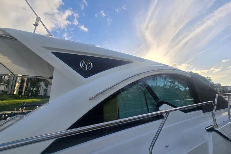  Yacht Photos Pics 2018 Cruisers Yachts 50 Cantius with sleek design against a vibrant sky backdrop.