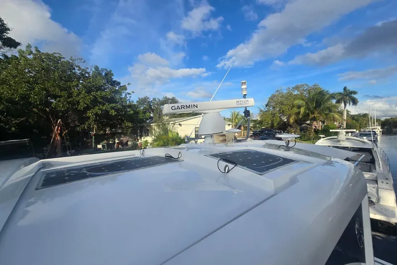  Yacht Photos Pics 2018 Cruisers Yachts 50 Cantius with Garmin radar, docked near lush greenery.