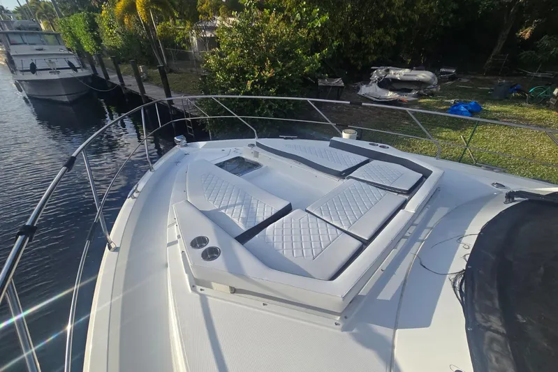  Yacht Photos Pics 2018 Cruisers Yachts 50 Cantius with luxurious deck seating and scenic waterway view.