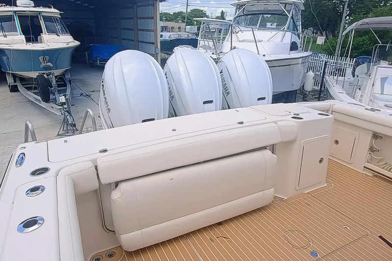 335-712 Used Yacht Photos Pics 2021 Grady-White Freedom 375 boat with triple Yamaha engines in a marina setting.