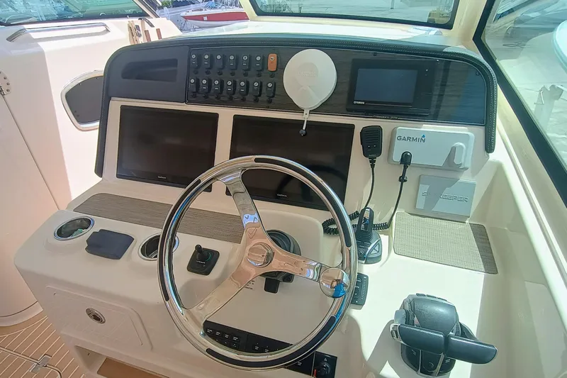 335-712 Used Yacht Photos Pics 2021 Grady-White Freedom 375 helm with steering wheel, Garmin electronics, and control panel.