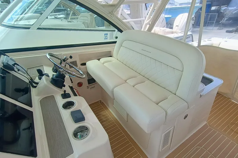 335-712 Used Yacht Photos Pics 2021 Grady-White Freedom 375 boat interior with steering wheel and plush seating.